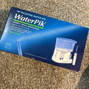 New in box Waterpik family oral irrigator with everything shown.  New in box